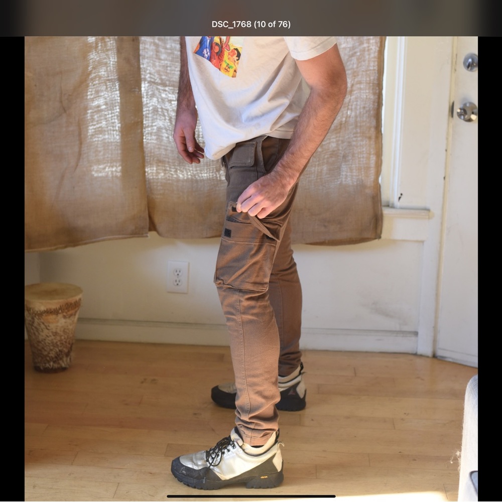 Taupe Cargo pants with multiple pockets. Slim fit. Model is 6’2 190lbs